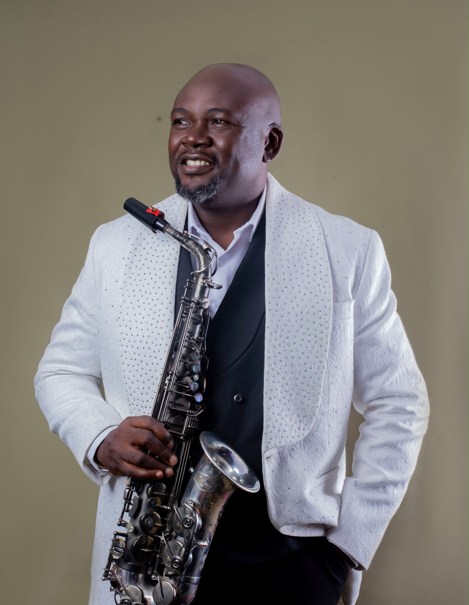 Segun Oluwayomi standing with saxophone
